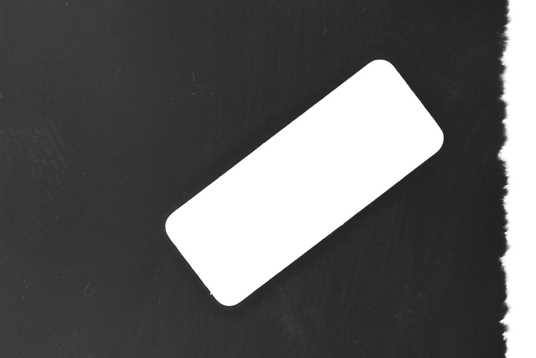 Abstract minimalist image featuring a white rectangle on a black background.